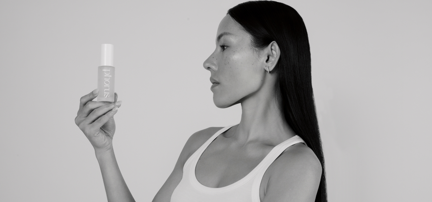 Black and white image of young women holiding phorus hyperpigmentation serum